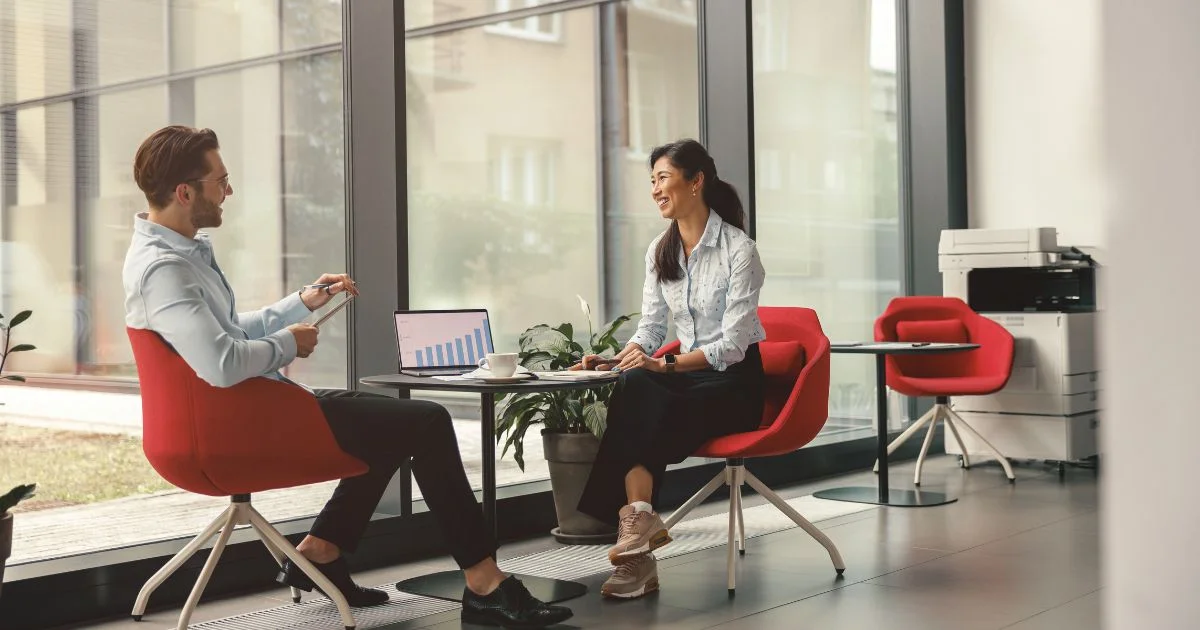 Two professionals talking at office table
